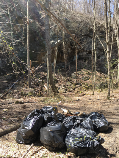 Pile of heavy garbage bags in woods